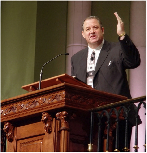 Pastor Gary Randall preaching from the pulpit at Elmwood Baptist Church
